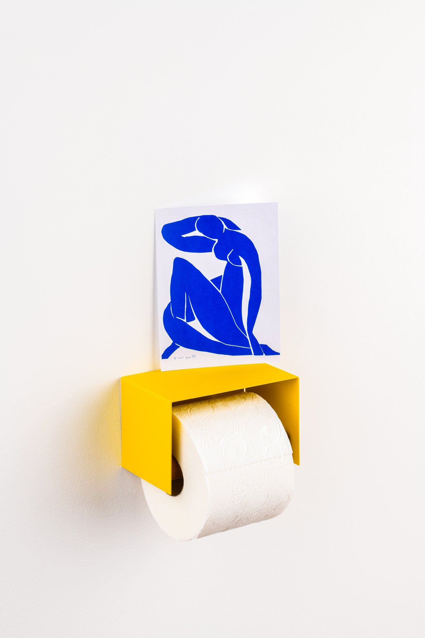 yellow toilet paper holder in nice design where you can put things on top like a phone or some small accessories