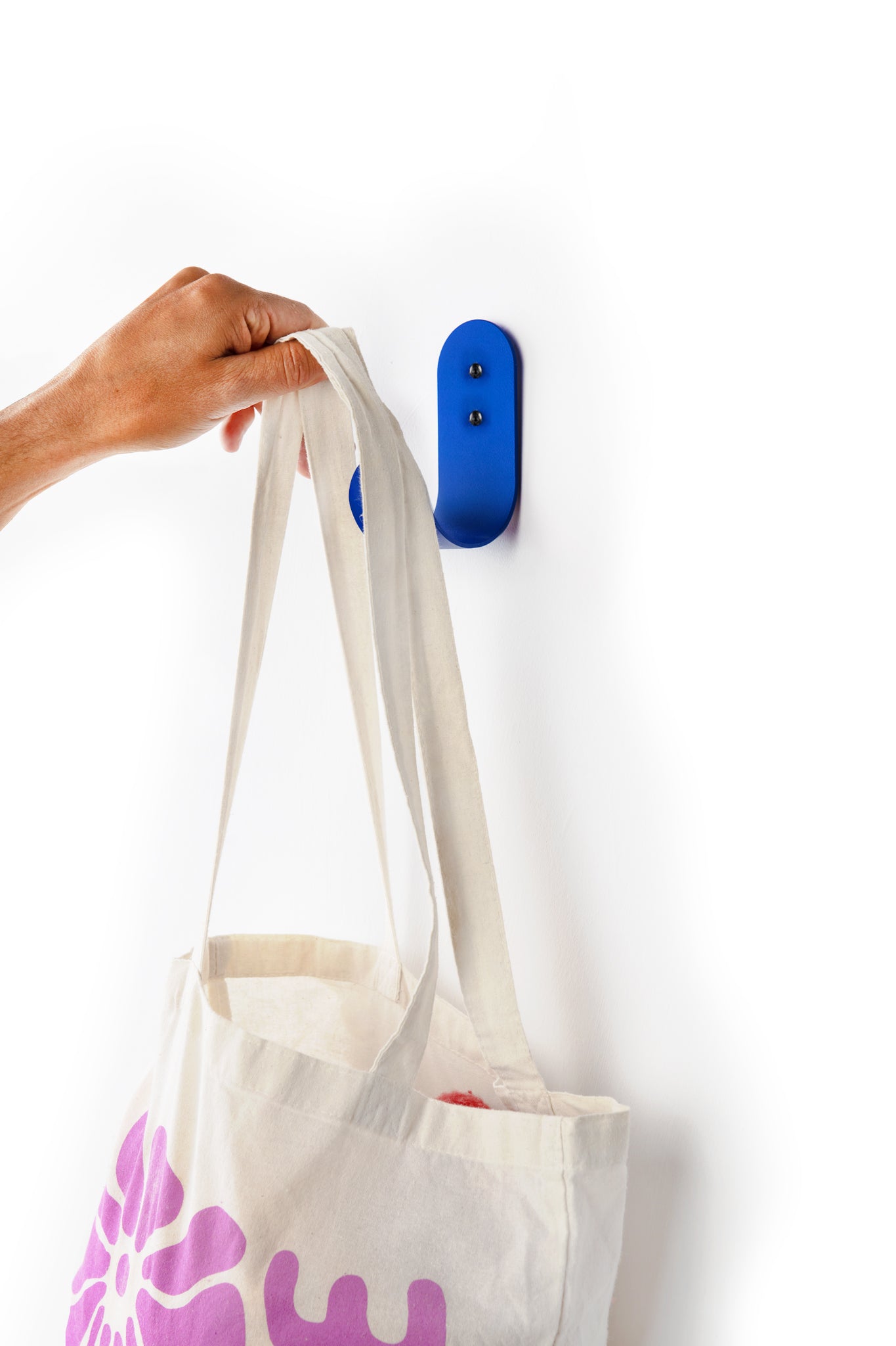 blue wall hook with white totebag