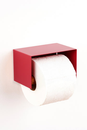 Red wall-mounted toilet paper holder with a roll of toilet paper on a white background