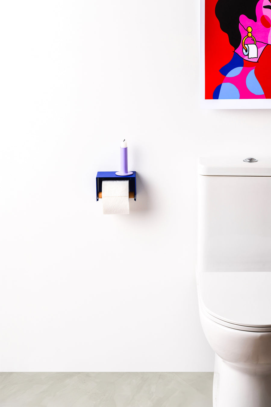blue toilet paper holder in nice design where you can put things on top like a phone or candle or some small accessories. 
