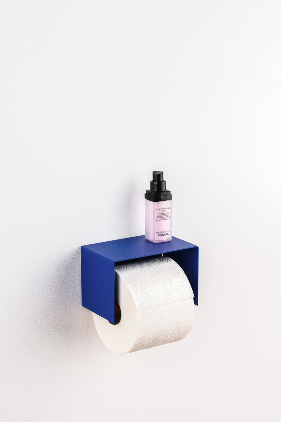 blue toilet paper holder in nice design where you can put things on top like a phone or candle or some small accessories. 