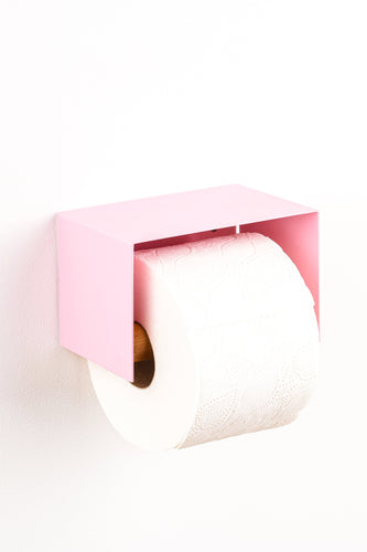 pink toilet paper holder in nice design where you can put things on top like a phone or candle or some small accessories. 