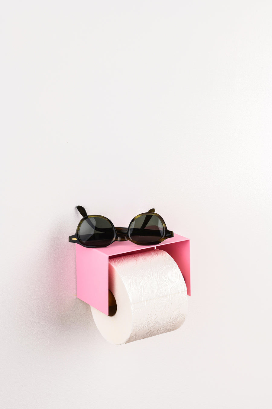 pink toilet paper holder in nice design where you can put things on top like a phone or candle or some small accessories.  