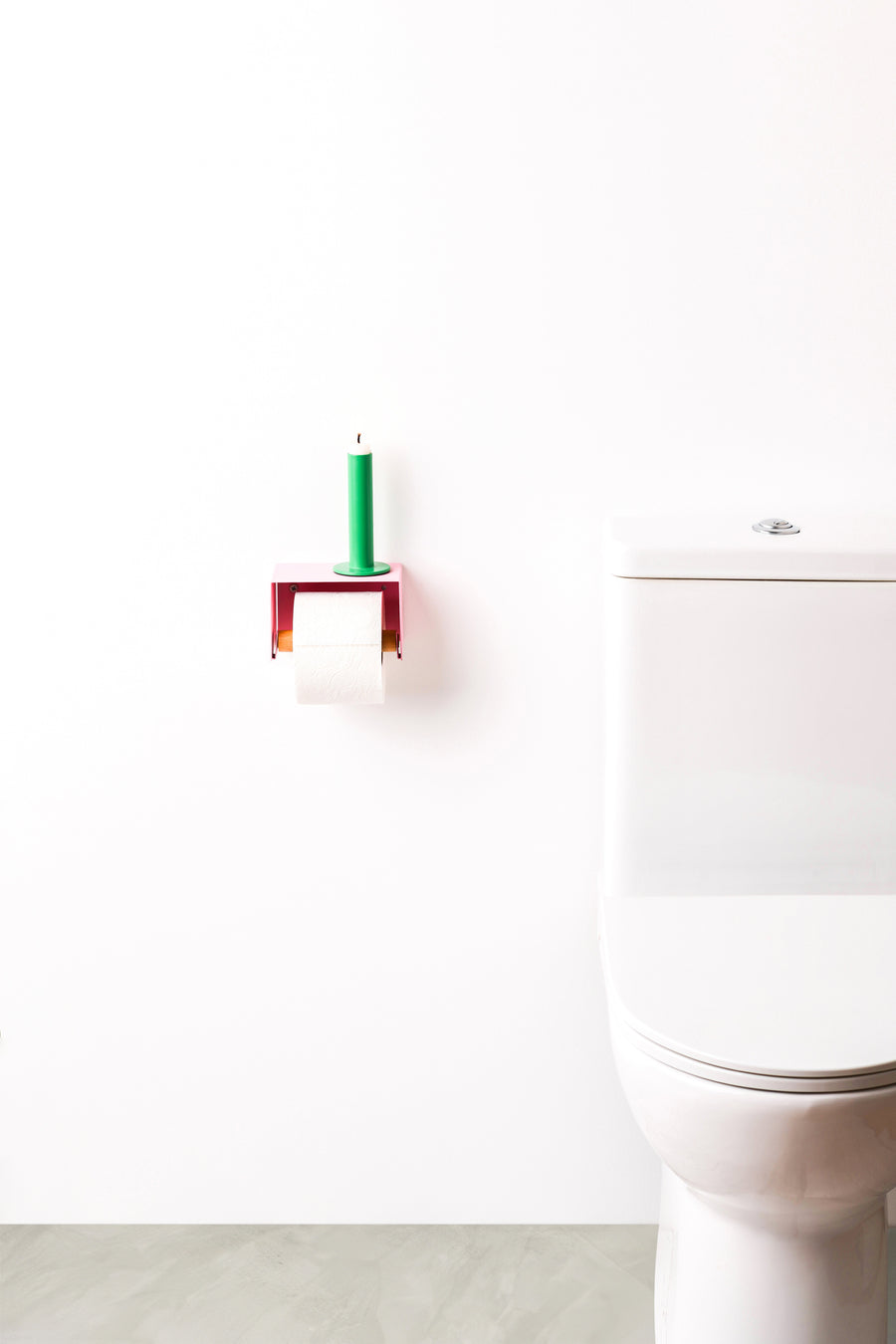 pink toilet paper holder in nice design where you can put things on top like a phone or candle or some small accessories. 