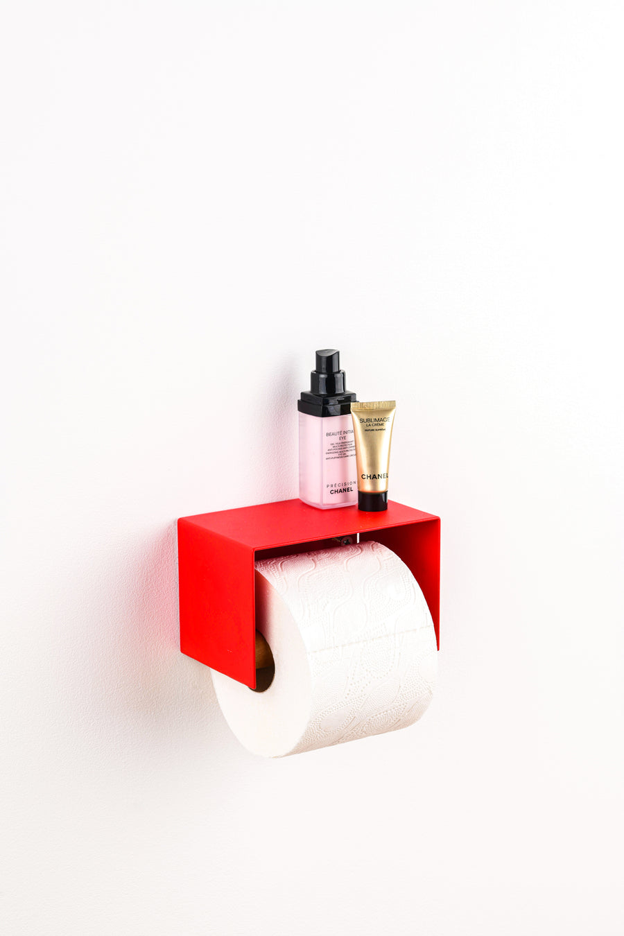 red toilet paper holder in nice design where you can put things on top like a phone or candle or some small accessories