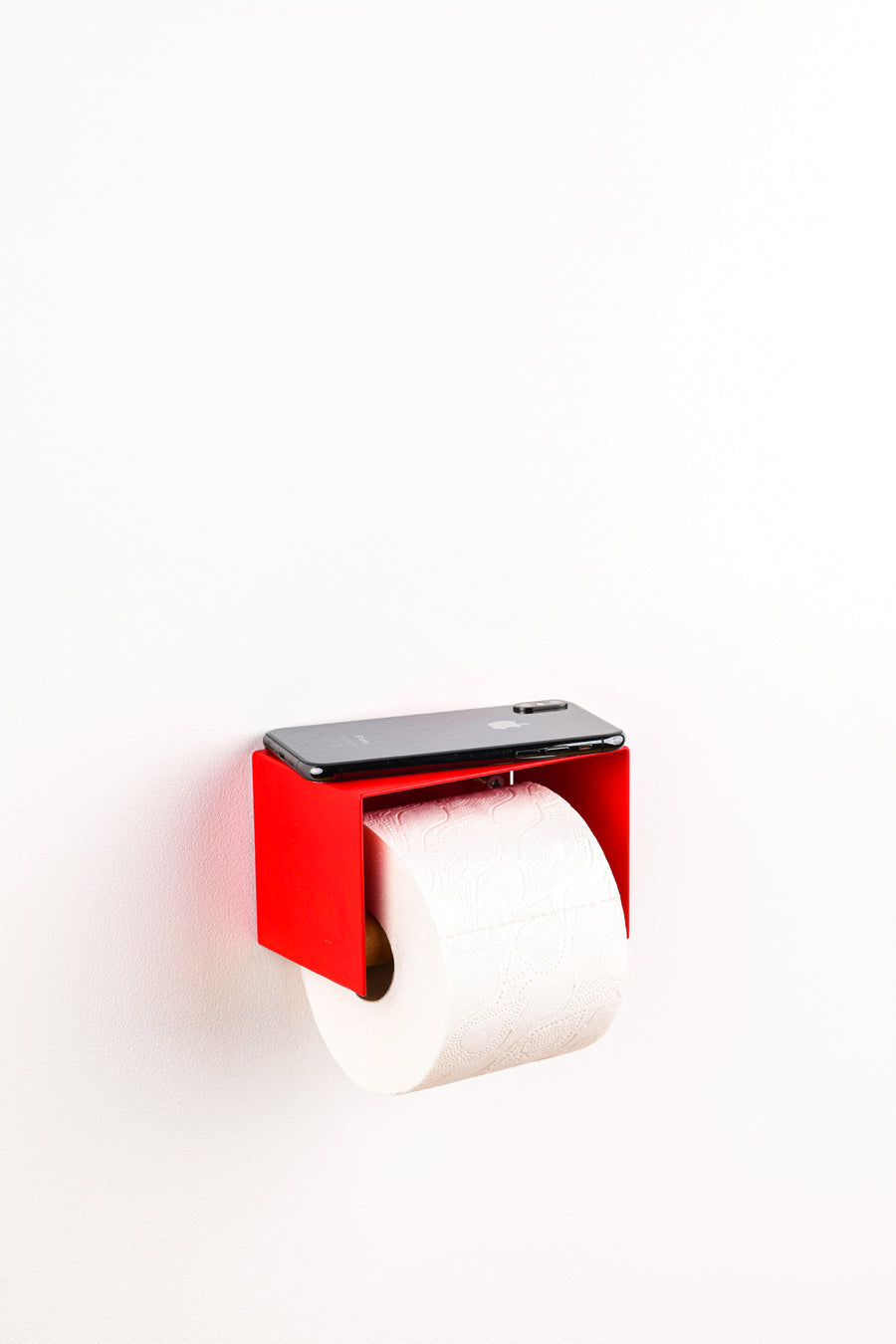 red toilet paper holder in nice design where you can put things on top like a phone or candle or some small accessories