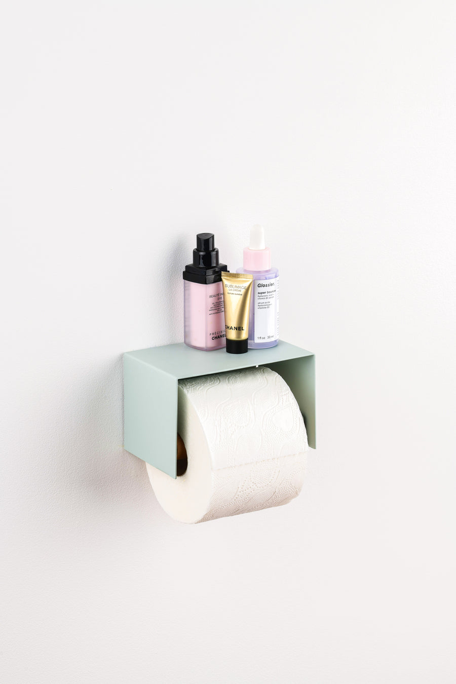 sage green toilet paper holder in nice design where you can put things on top like a phone or candle or some small accessories.  