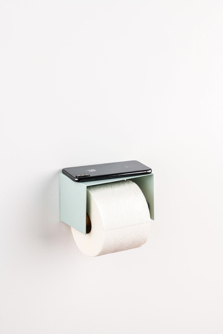 sage green toilet paper holder in nice design where you can put things on top like a phone or candle or some small accessories.  
