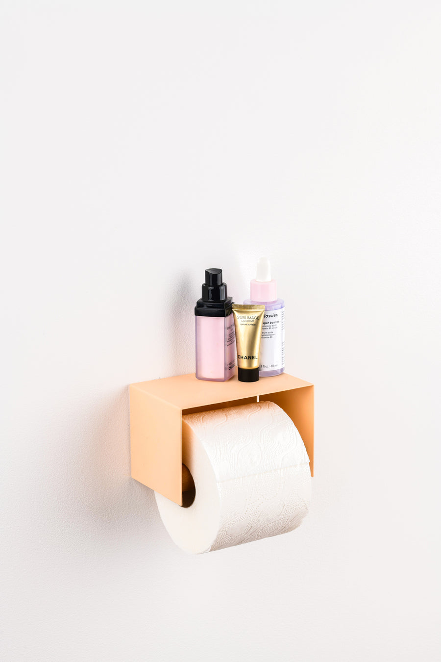 salmon pink toilet paper holder in nice design where you can put things on top like a phone or candle or some small accessories.  