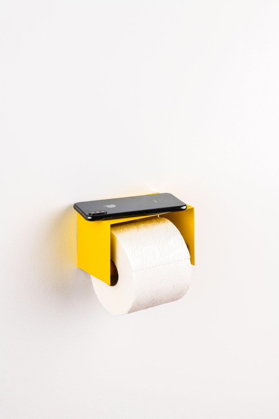 yellow toilet paper holder in nice design where you can put things on top like a phone or some small accessories