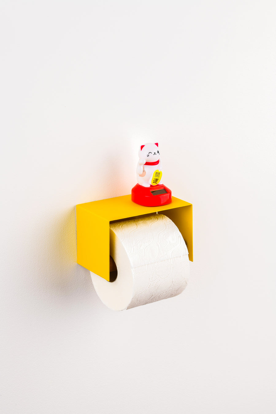 yellow toilet paper holder in nice design where you can put things on top like a phone or some small accessories