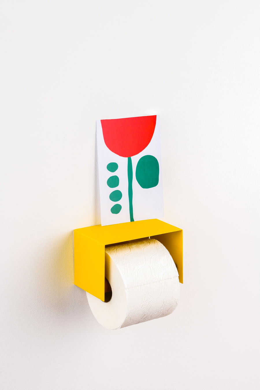 yellow toilet paper holder in nice design where you can put things on top like a phone or some small accessories