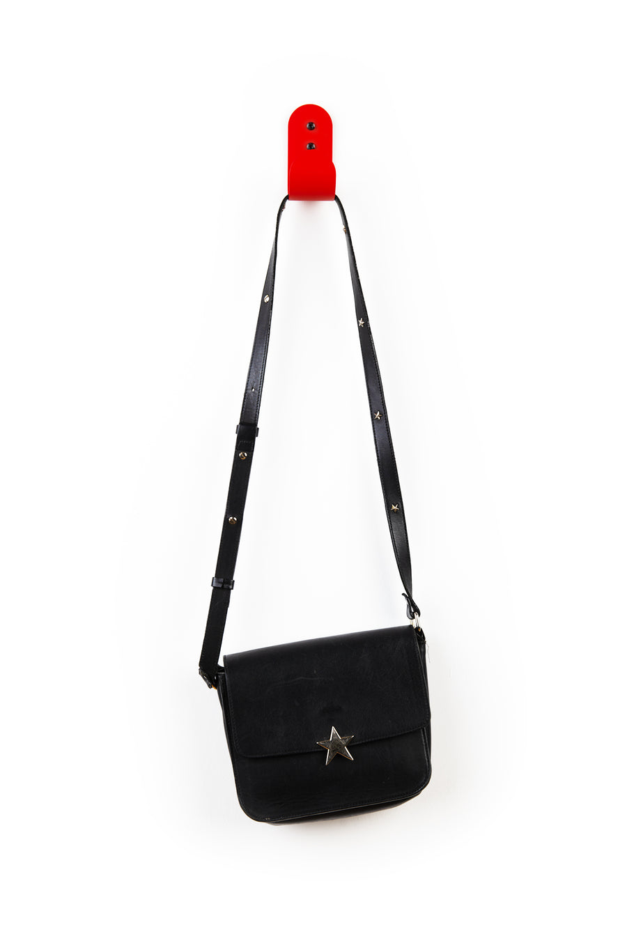 red wall hook with blue purse
