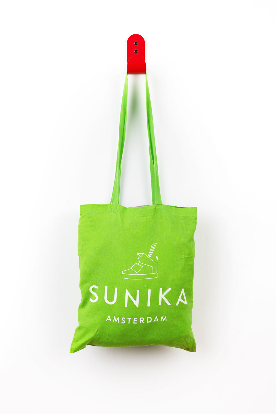 red wall hook with green sunika amsterdam bag