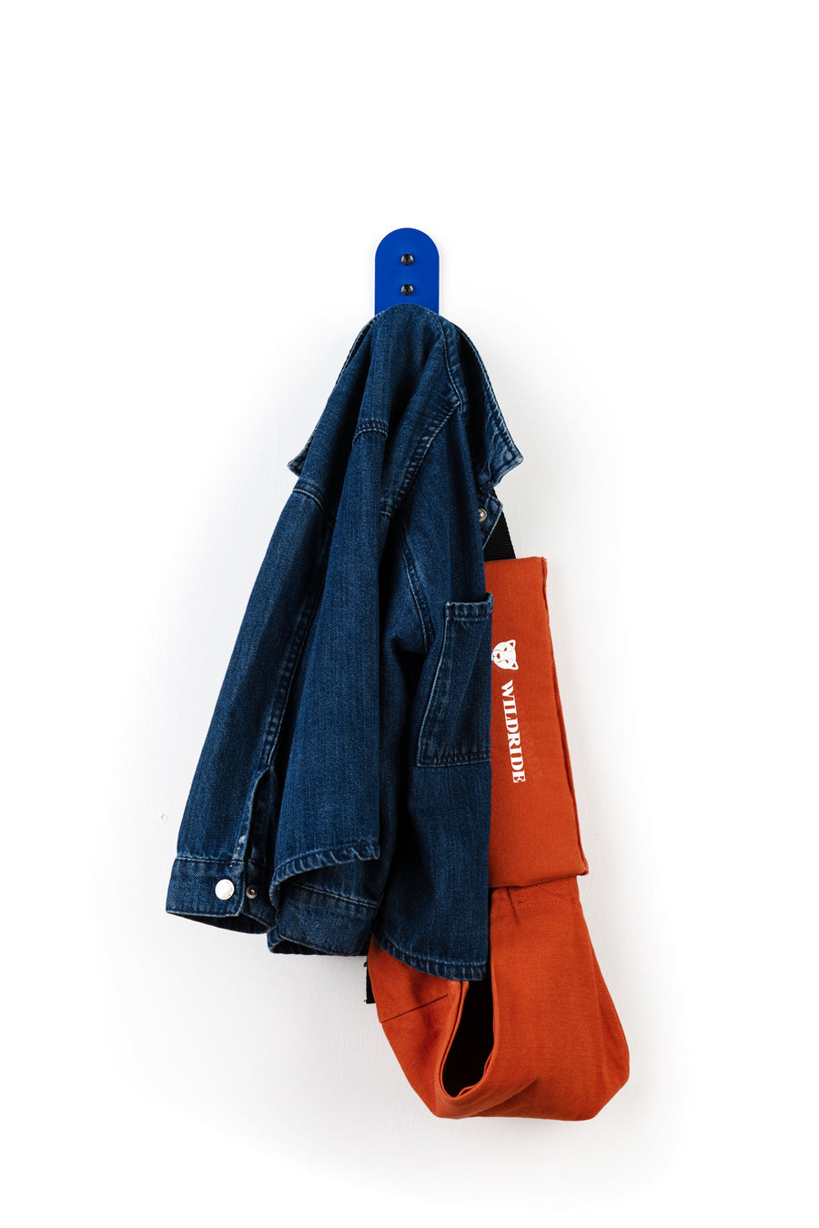 Blue wall hook with blue denim kids jacket and wildride carrier