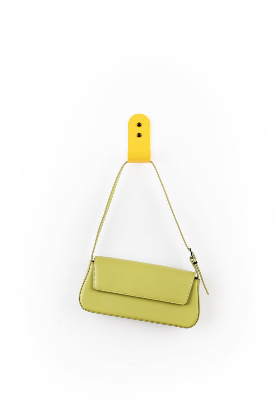 yellow wall hook with green purse