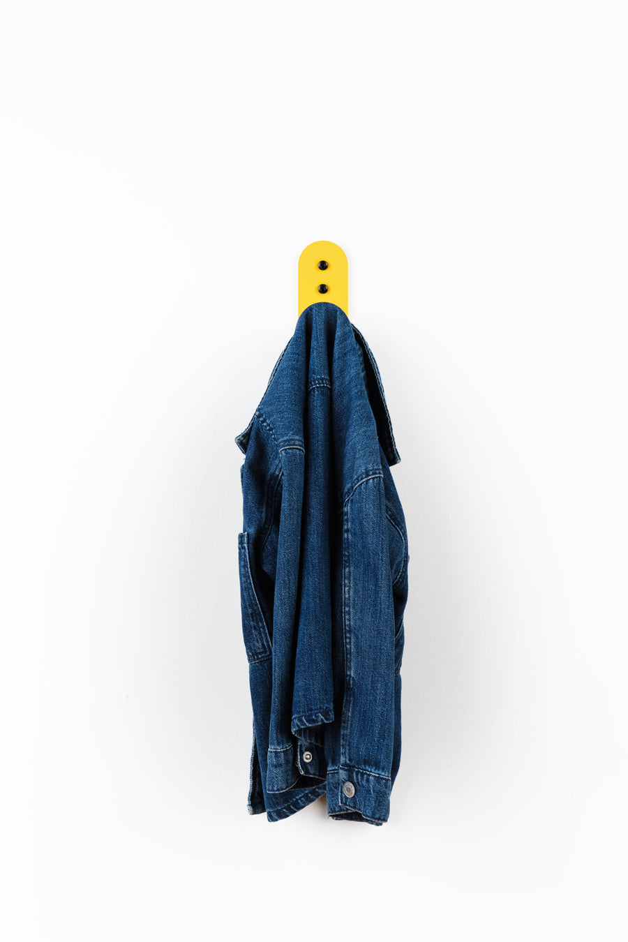 yellow wall hook with blue denim kids jacket