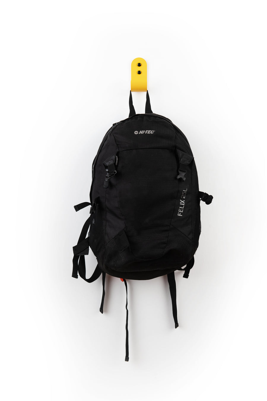 yellow wall hook with black hi-tec back pack