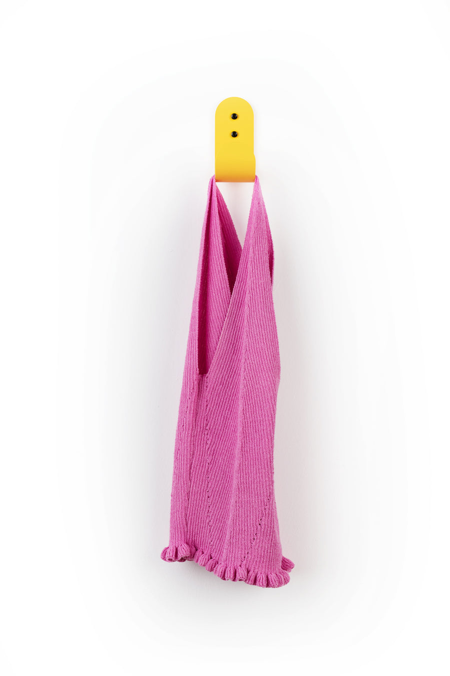 yellow wall hook with pink shirt