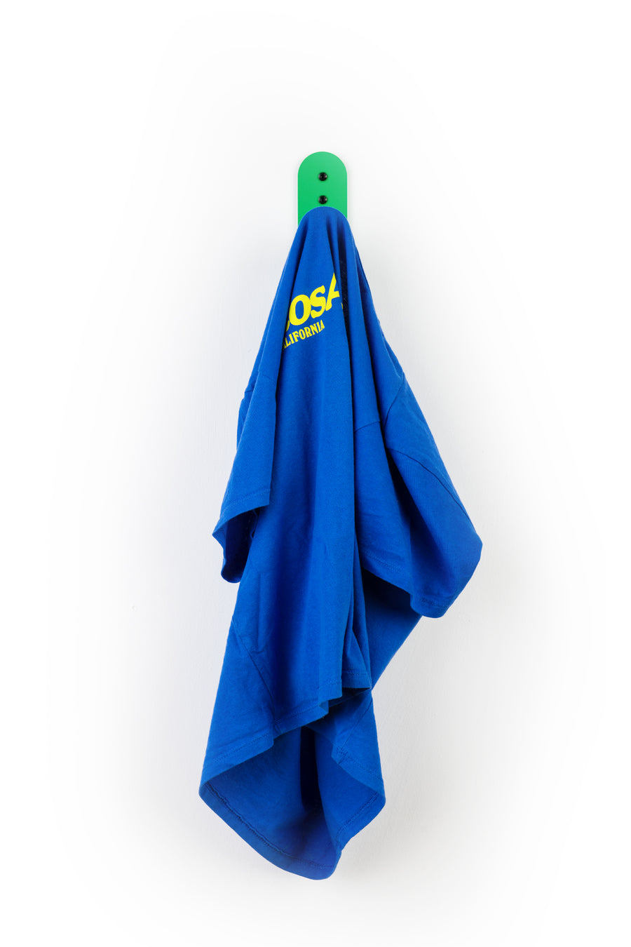 green wall hook with blue t-shirt hanging