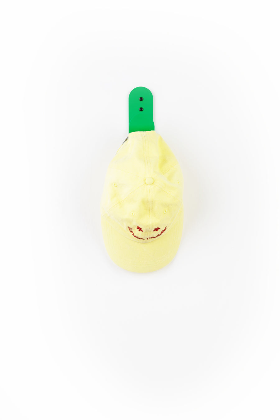 green wall hook with yellow cap