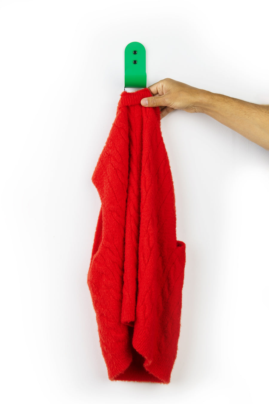 Green wall hook with red sweater