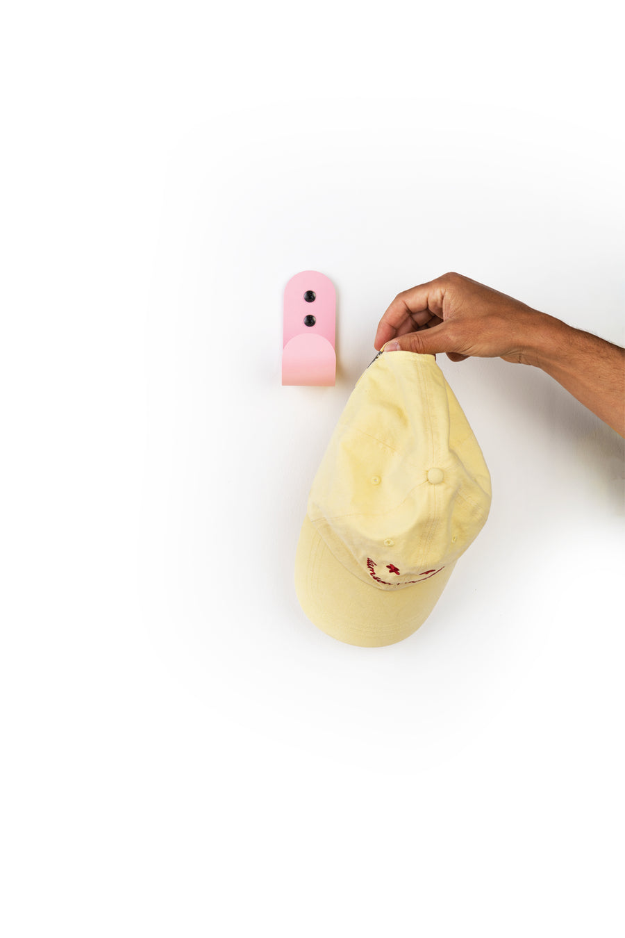 pink hook with yellow cap and hand moving