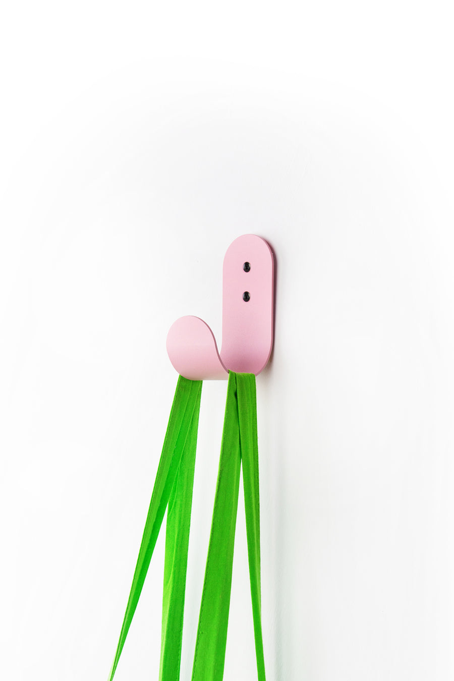 Pink wall hook with green tote bag