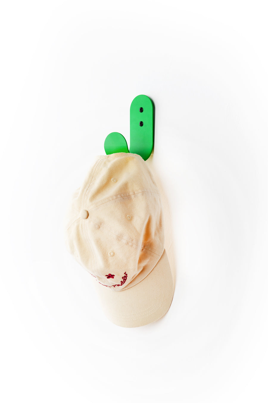 green wall hook with white cap