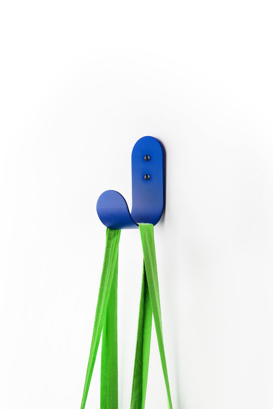 blue wall hook with green tote bag